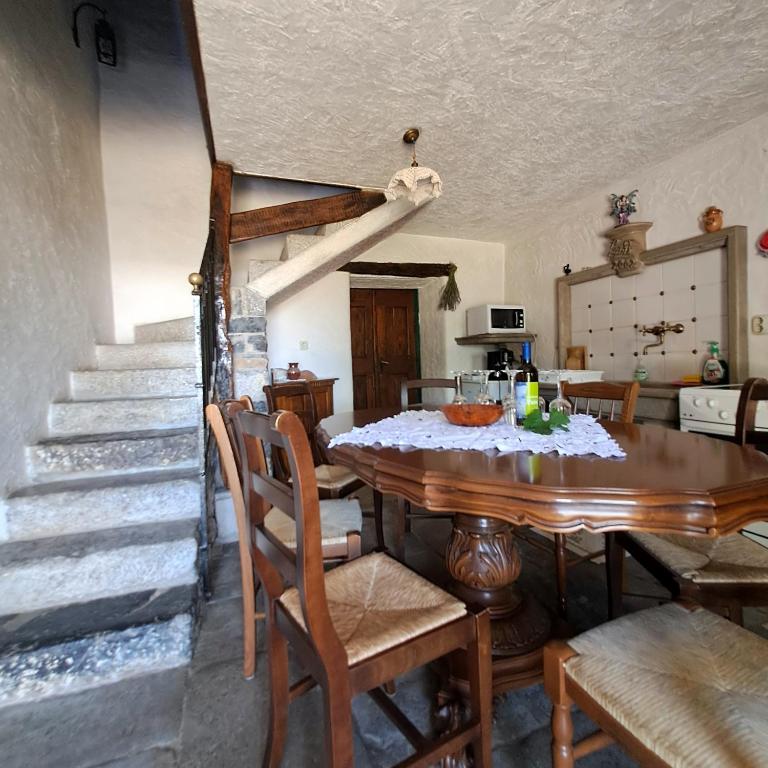 a kitchen and dining room with a table and stairs at Holiday house Luin in Komen