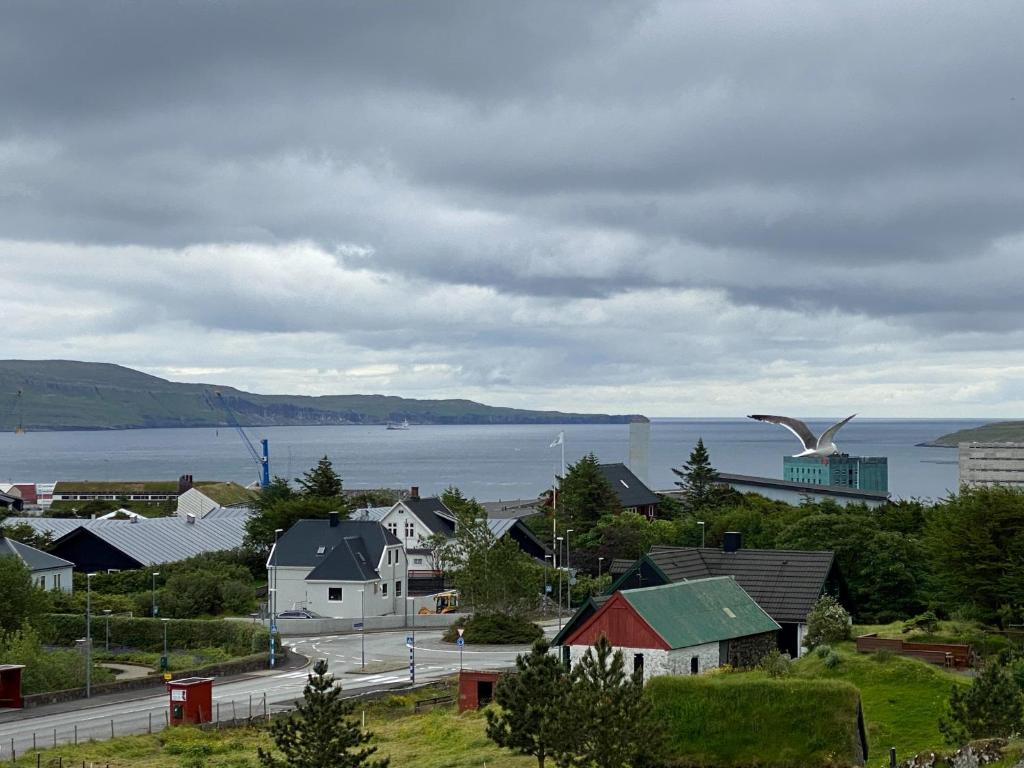 a town with a view of a body of water at 1 Bedroom Home - Private Balcony - Parking On Site in Tórshavn