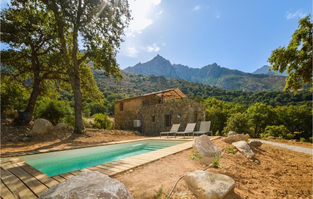 a swimming pool in front of a house with mountains at Beautiful Home In Feliceto With Wifi in Feliceto
