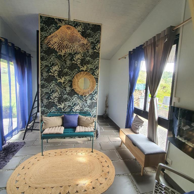 a living room with a couch and a rug at À l'aube du sacré coeur in La Plaine des Palmistes