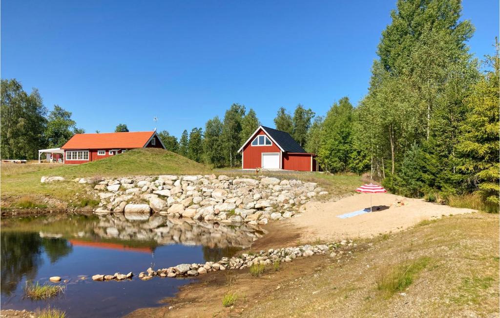 a house on a hill next to a body of water at Stunning Home In Vittsj With 3 Bedrooms in Vittsjö