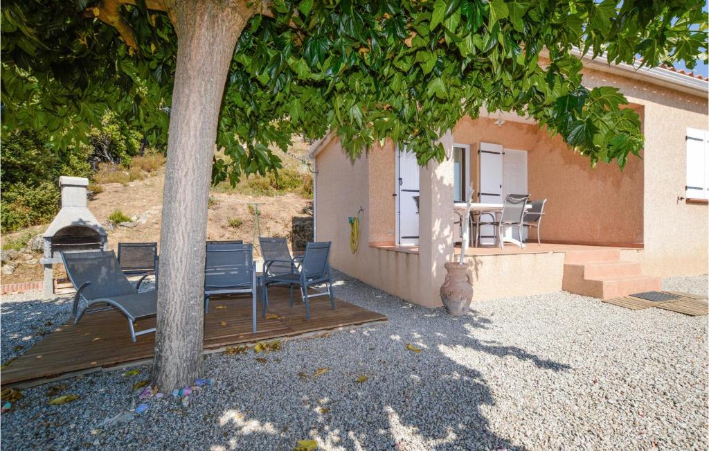 a cat sitting on a deck under a tree at Nice Home In Casalabriva With 2 Bedrooms And Wifi in Casalabriva