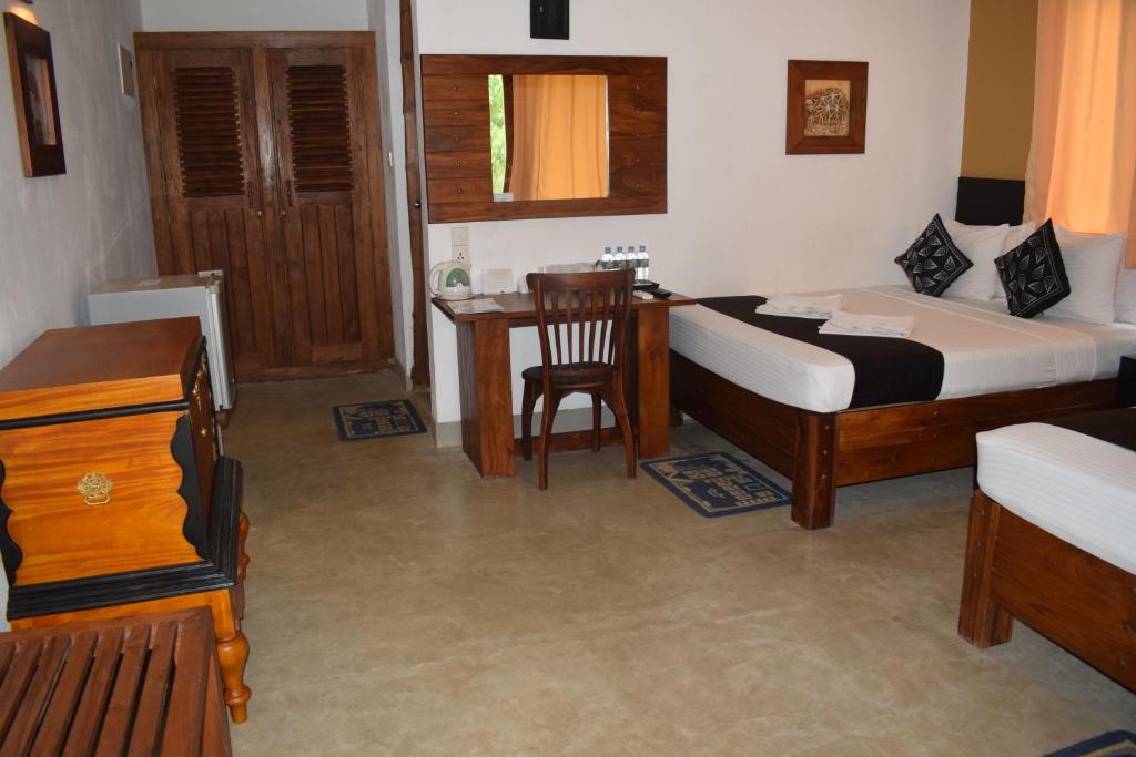 Postel nebo postele na pokoji v ubytování Nil Diya Mankada Safari Lodge