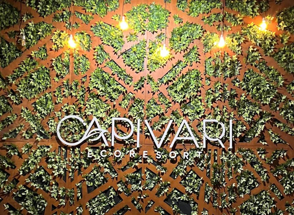 a sign that reads carvalhal is lit up with lights at Capivari Ecoresort in Campina Grande do Sul