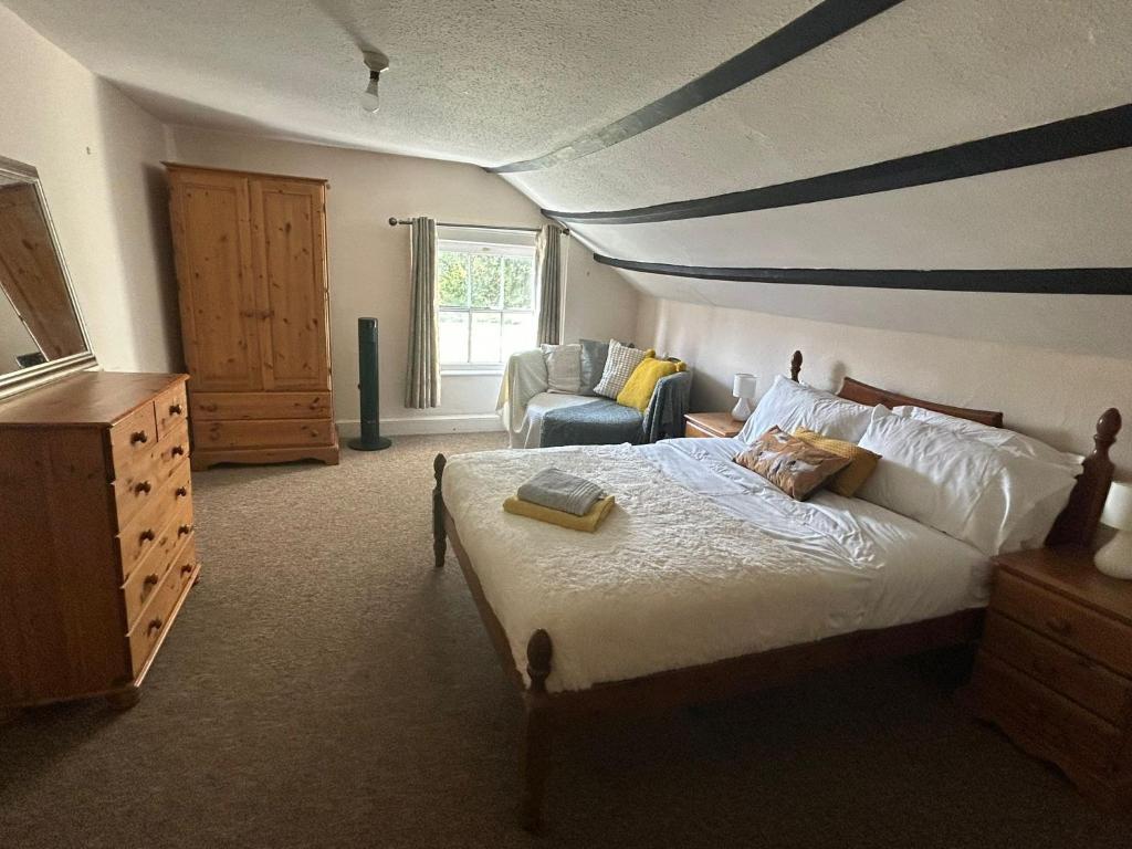 a bedroom with a bed and a striped ceiling at Number 2 at The Red Lion in Huntley