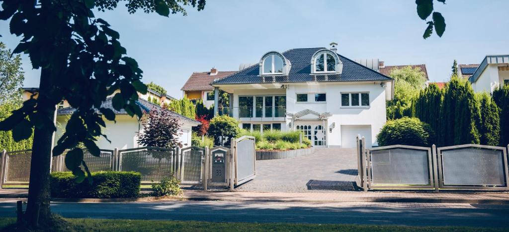 a white house with a gate in front of it at Neue Technologie Systemlösungen GmbH in Osterode