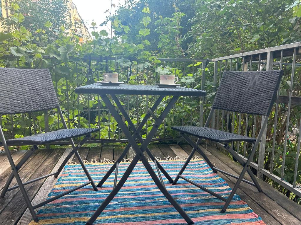 a table and two chairs sitting on a deck at Urban Apartment for Erasmus Student, Zentrum in Graz