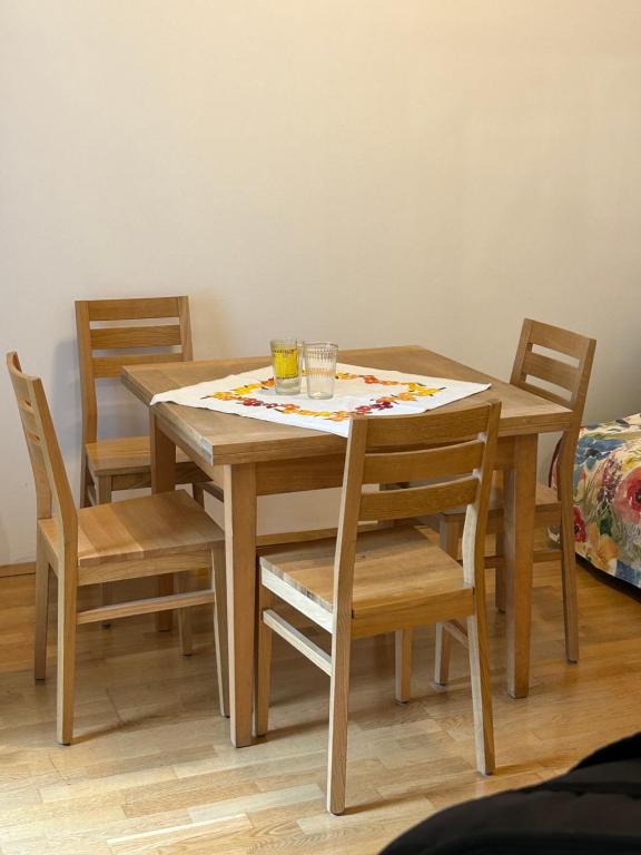 a wooden table with chairs and a table cloth on it at Urban Apartment for Erasmus Student, Zentrum in Graz