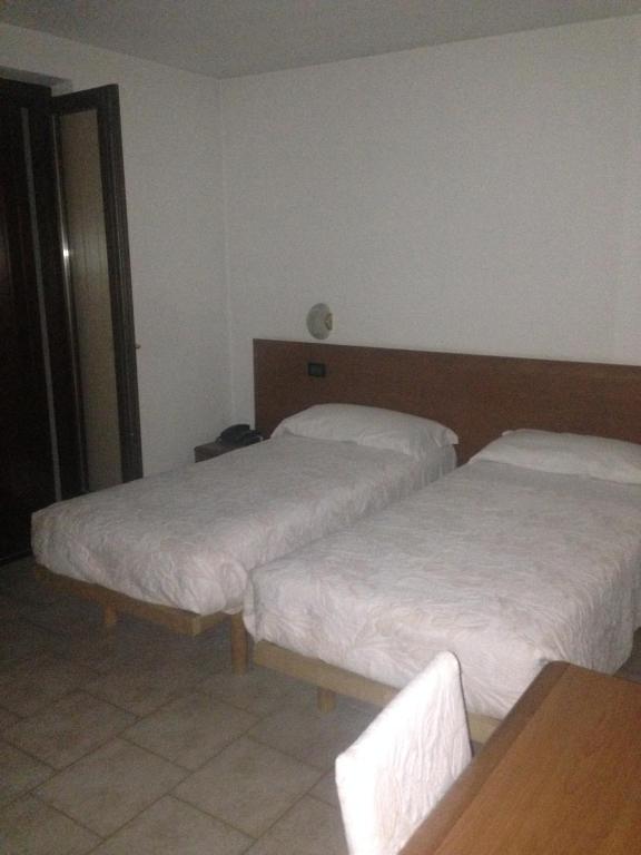 Postel nebo postele na pokoji v ubytování Hotel Scandola