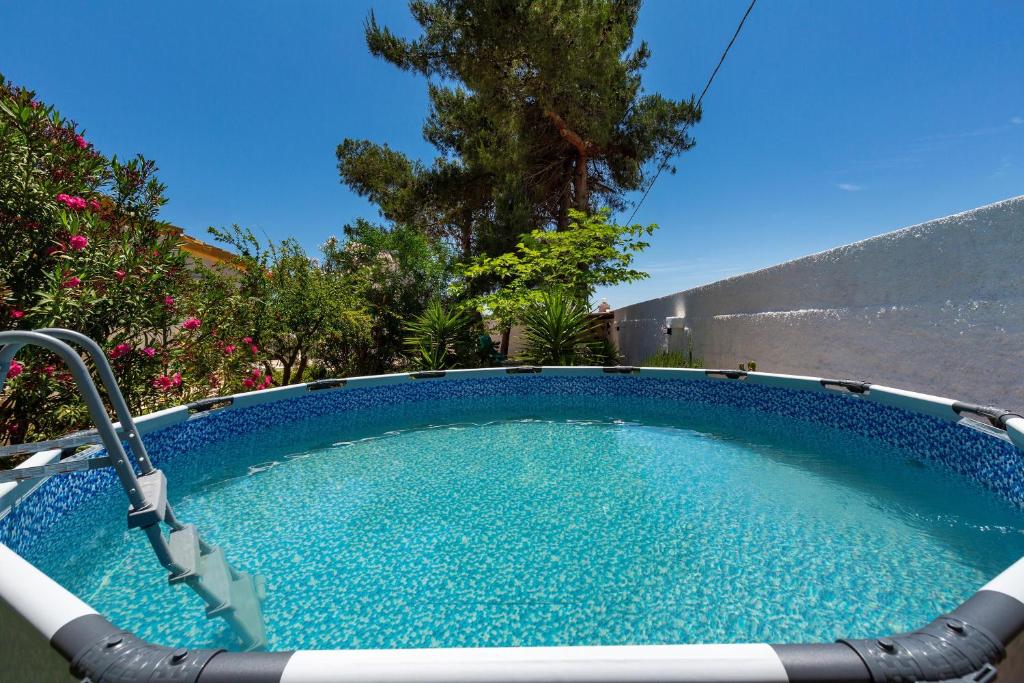 Una piscina con agua azul en un patio. en Casa di Margherita by BarbarHouse, en San Pietro in Bevagna