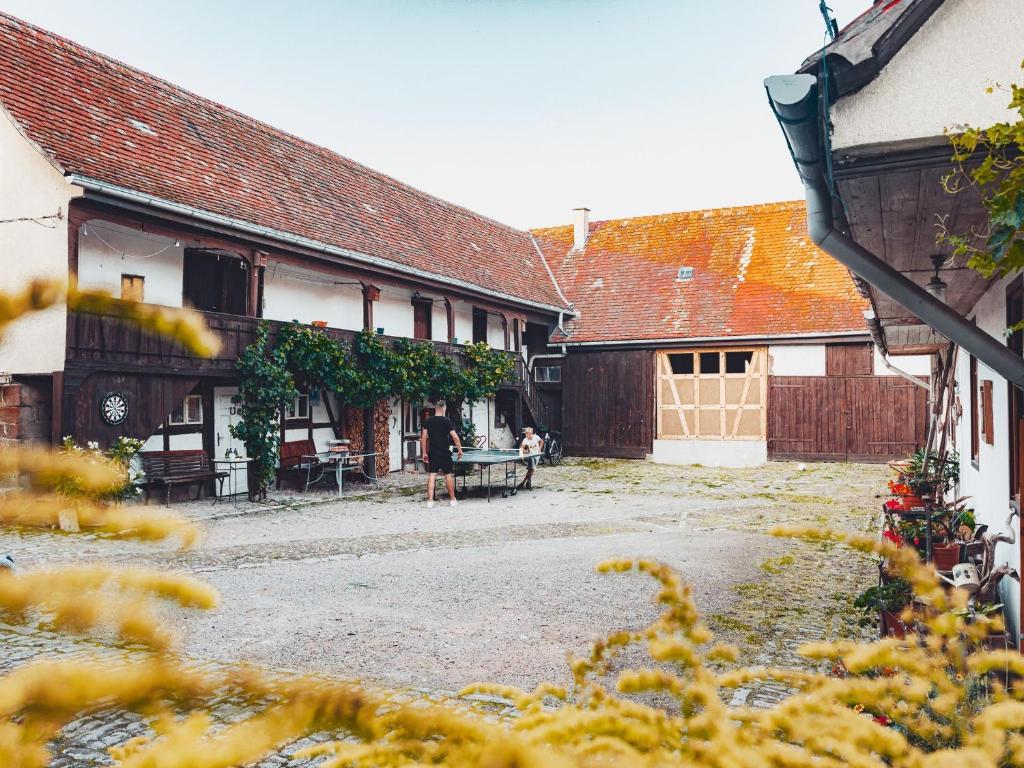 a group of buildings with people sitting in a courtyard at Ferienwohnung Brühler Hof in Bad Berka