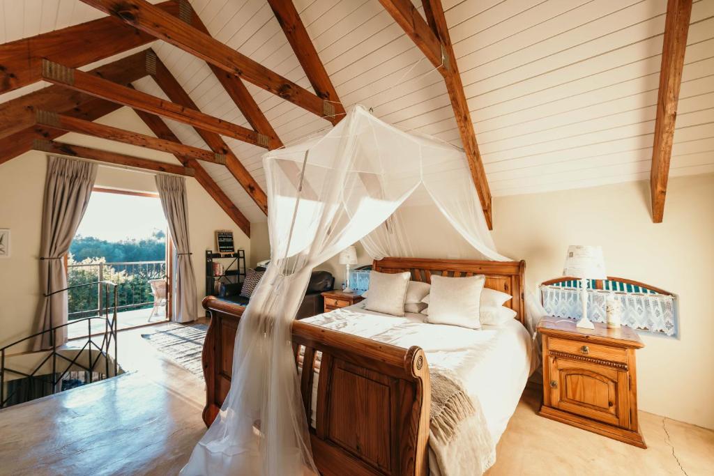 a bedroom with a bed with a veil at Silky Oaks Couples Retreat in Riebeek-Kasteel