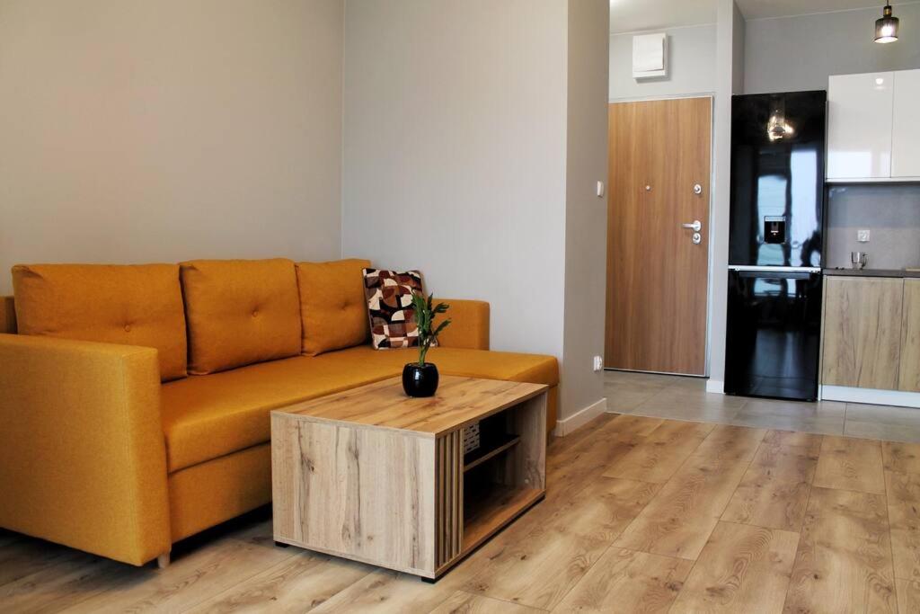 a living room with a couch and a coffee table at Golden Apartments Gdansk&P29 in Gdańsk
