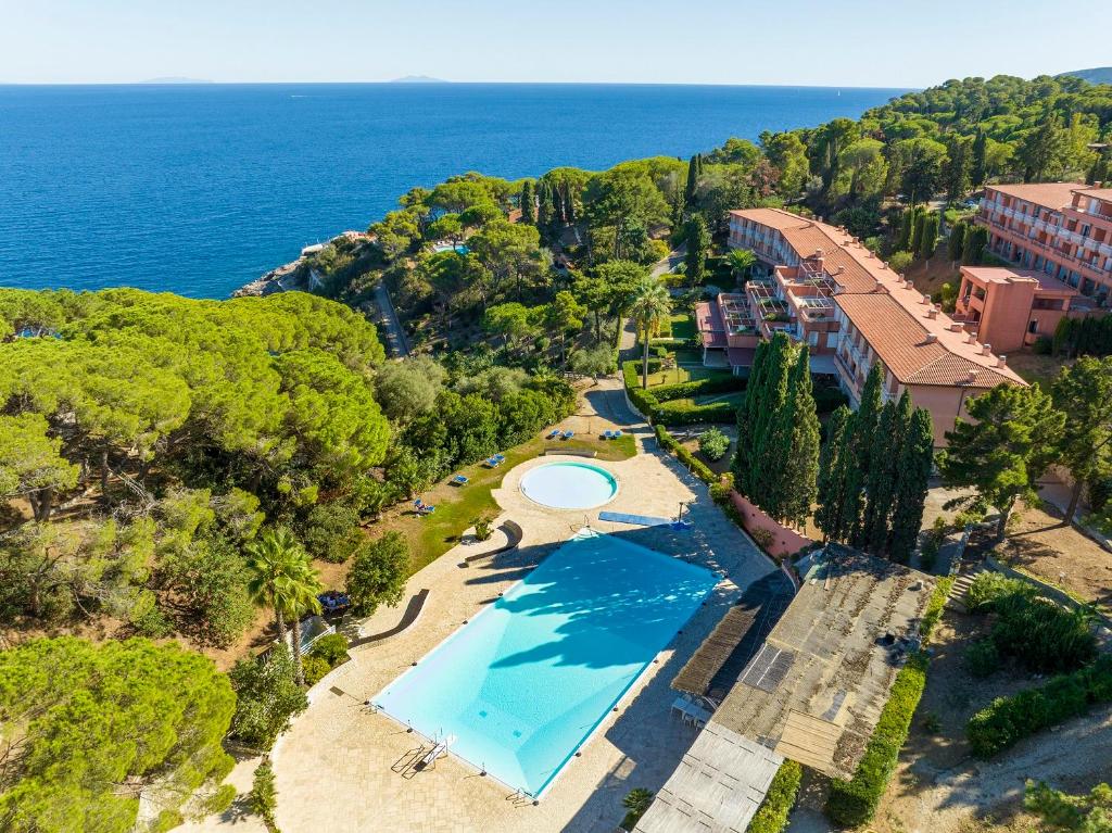 an aerial view of a resort with a swimming pool and the ocean at Capo d'Arco Apartments in Capo D'Arco
