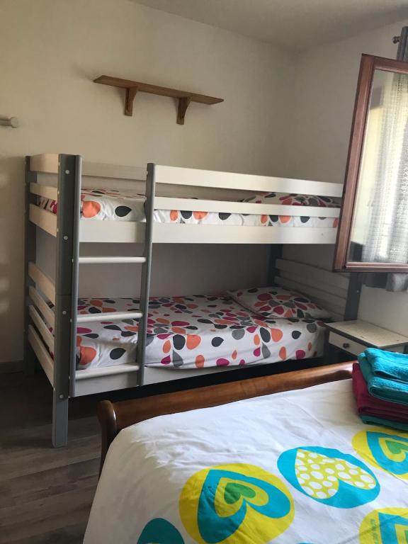 a bedroom with two bunk beds and a bed at CHEZ ANTOINE in Saint-Pierre-dels-Forcats