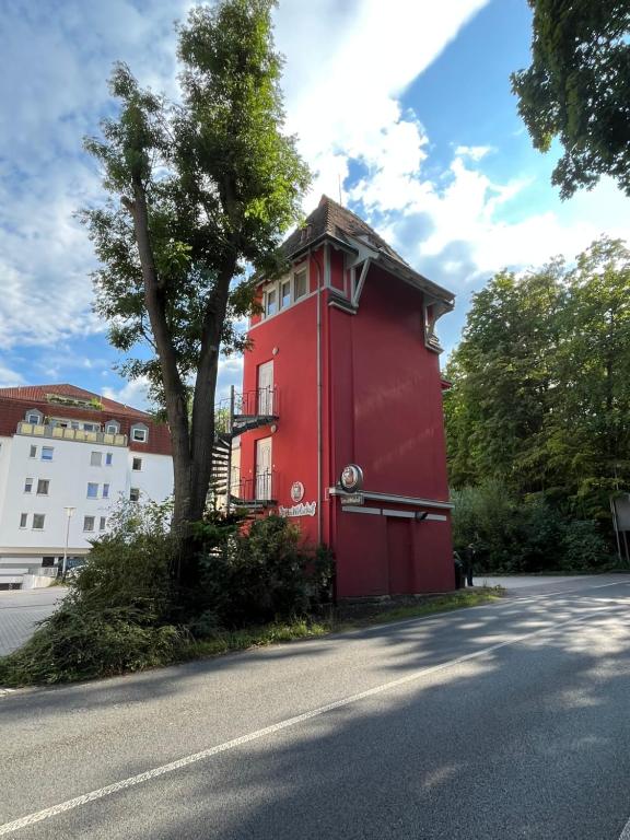 a red building on the side of a street at Turmwohnung in Kreischa