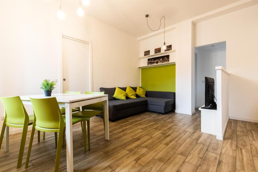 a living room with a table and chairs and a couch at Bellarmino 21 in Milan