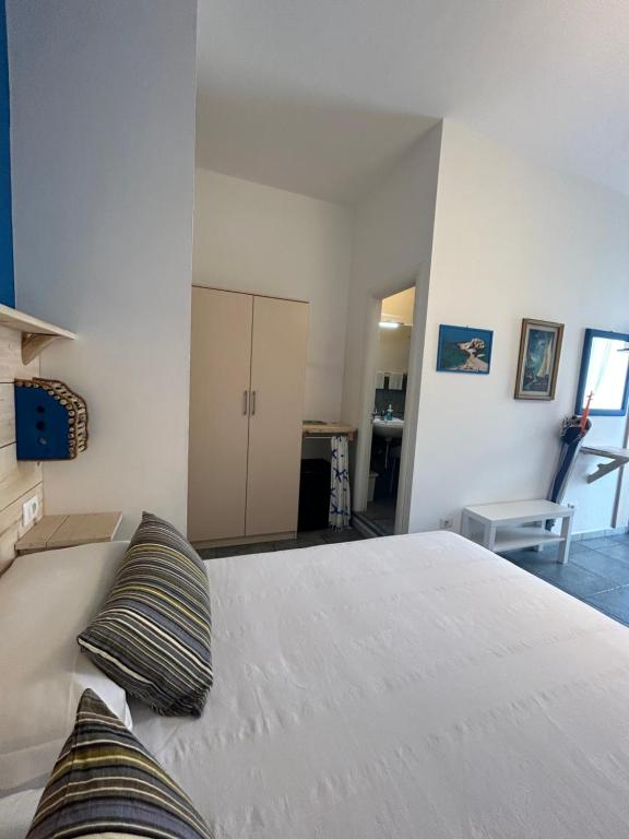 a bedroom with a large white bed with two pillows at Arcobaleno Tropea centro in Tropea