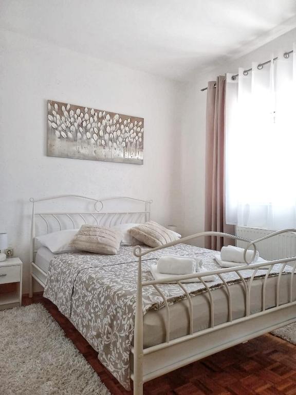 a white bedroom with a white bed and a window at Villa Prima Natura, Imotski private pool in Imotski