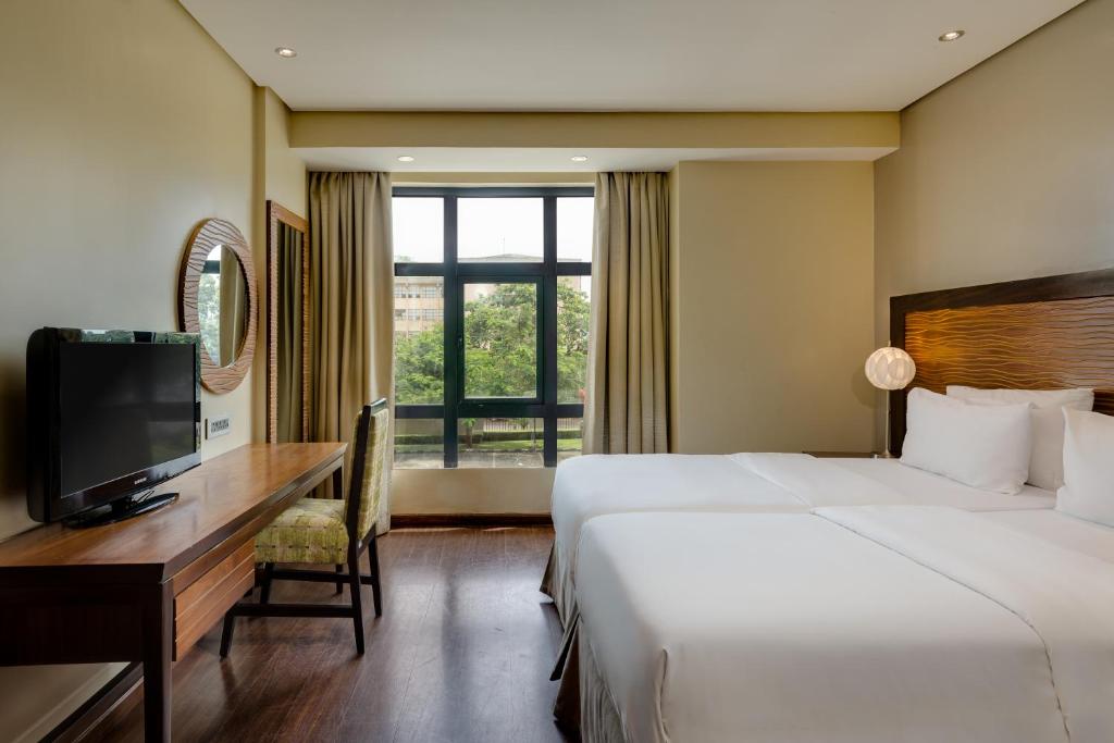 Postel nebo postele na pokoji v ubytování Protea Hotel by Marriott Benin City Select Emotan