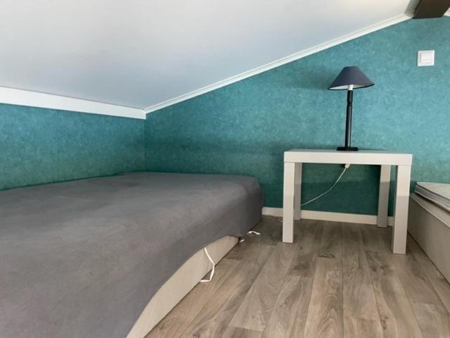 a bedroom with a bed and a table with a lamp at Guest house at Baltic Sea Oskarshamn in Oskarshamn