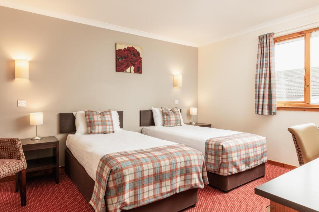 Postel nebo postele na pokoji v ubytování Highlander Hotel ‘A Bespoke Hotel’