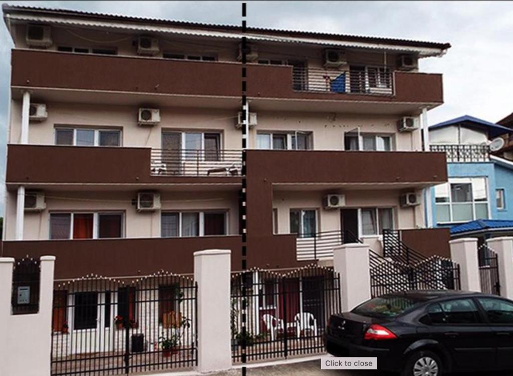 a black car parked in front of a building at Eforie Brio in Eforie Nord