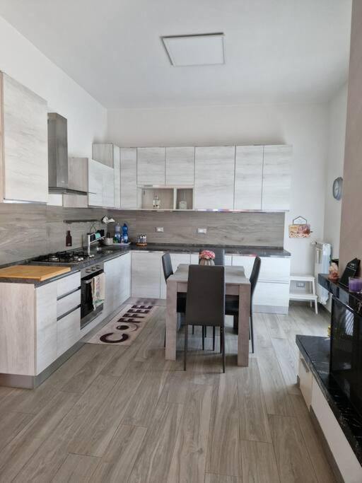 a kitchen with a table and a dining room at Susy's Home Appartamento in centro in Corchiano