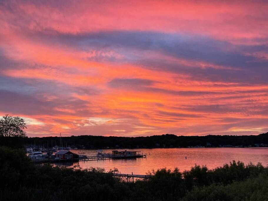a sunset over a body of water with boats at Hot Tub - Saugatuck/Douglas - Three Bedroom - Sleeps 8 in Douglas