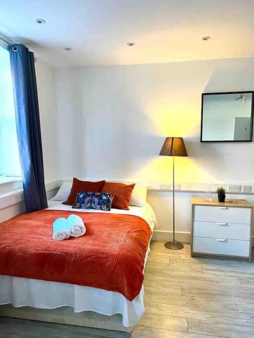 a bedroom with a bed with a towel on it at Spacious Studio flat in Central London in London