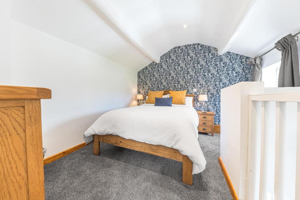 a bedroom with a bed and a dresser at The Black Dog Apartment in Dalton in Furness