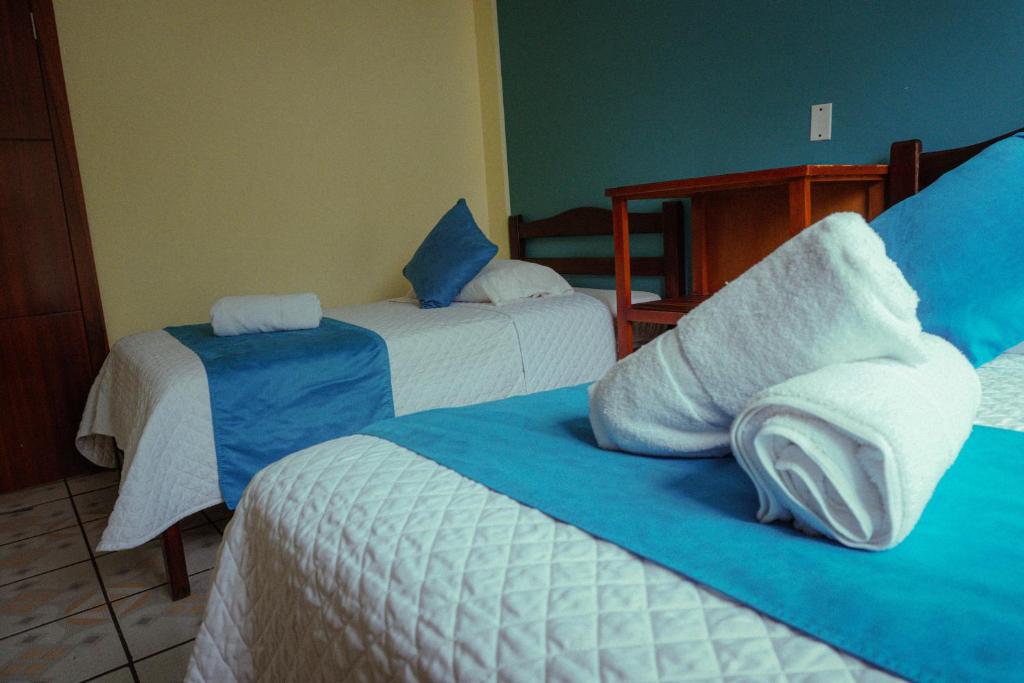 Postel nebo postele na pokoji v ubytování Hostal CañaLimeña