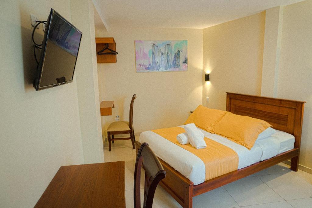 Postel nebo postele na pokoji v ubytování Hostal CañaLimeña