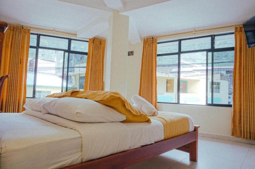 Postel nebo postele na pokoji v ubytování Hostal CañaLimeña