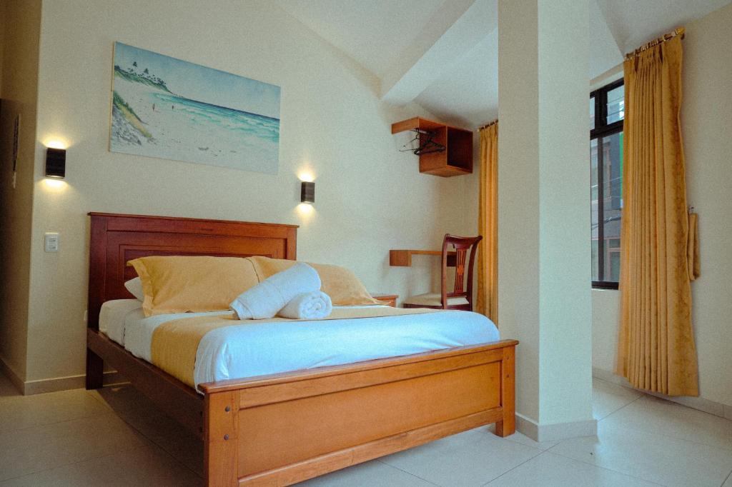 Postel nebo postele na pokoji v ubytování Hostal CañaLimeña