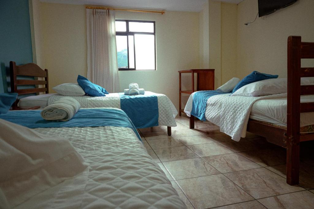 Postel nebo postele na pokoji v ubytování Hostal CañaLimeña