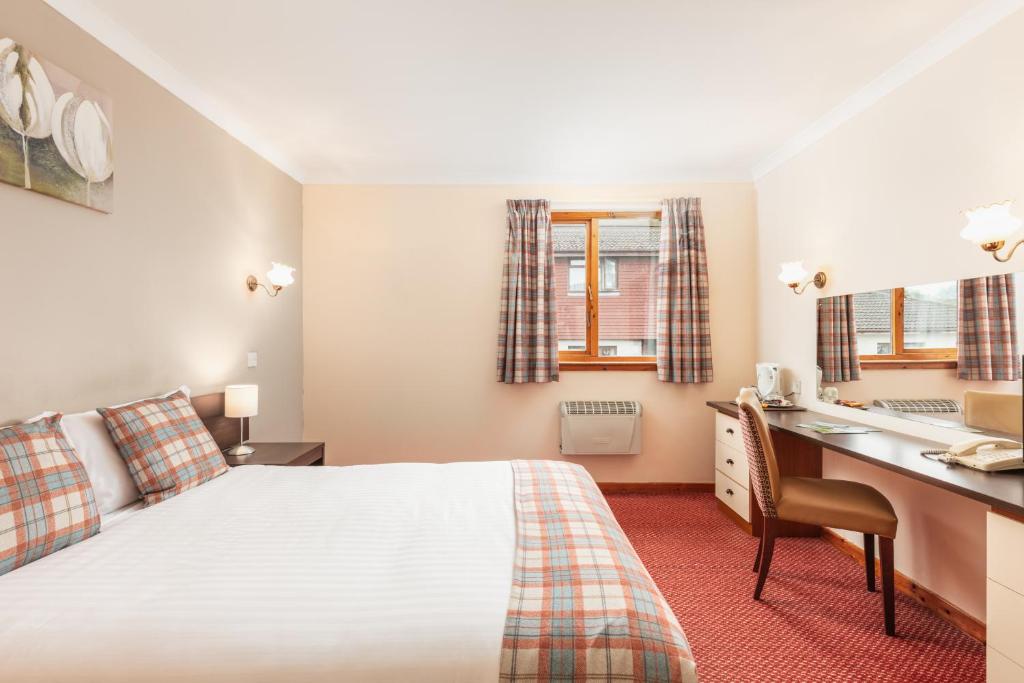Postel nebo postele na pokoji v ubytování Highlander Hotel ‘A Bespoke Hotel’
