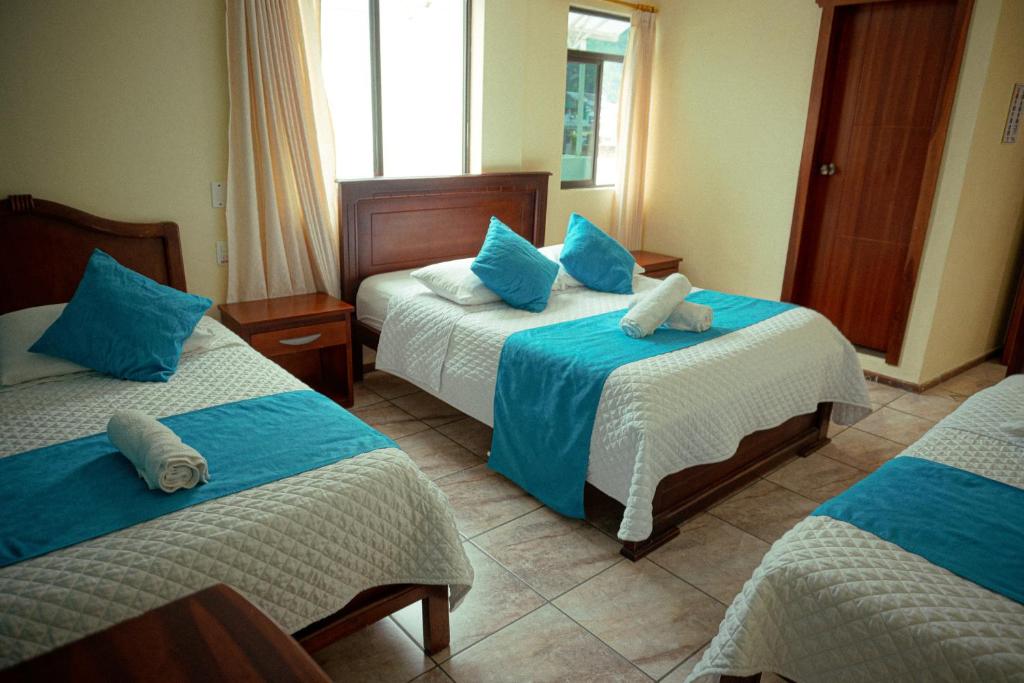 Postel nebo postele na pokoji v ubytování Hostal CañaLimeña