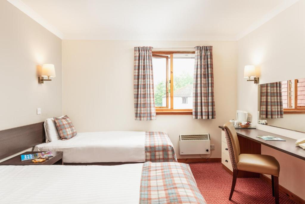 Postel nebo postele na pokoji v ubytování Highlander Hotel ‘A Bespoke Hotel’
