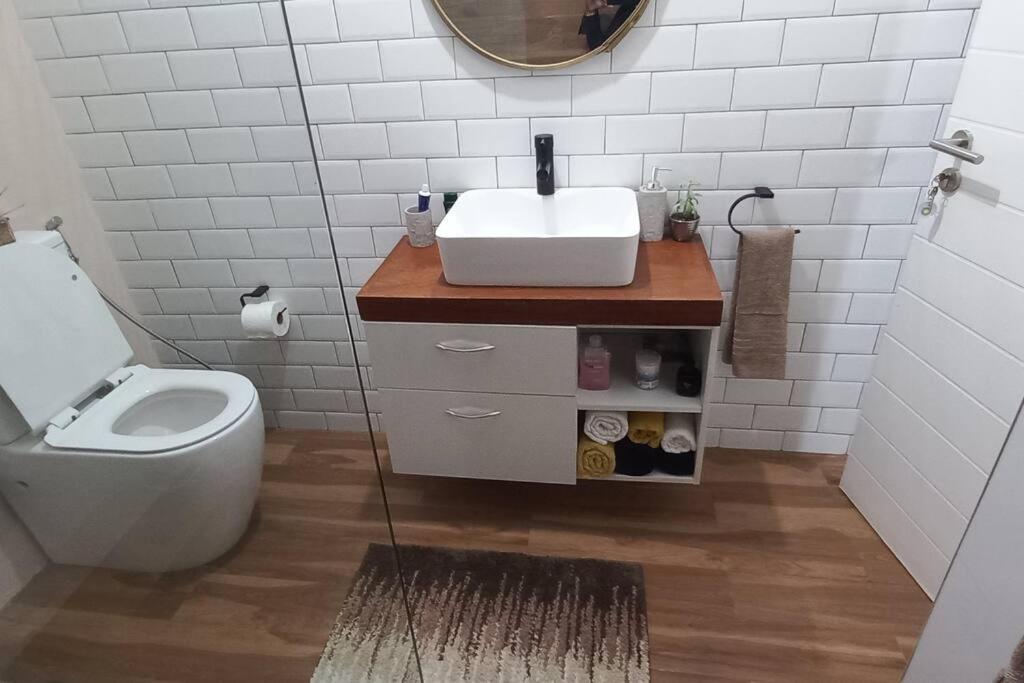 a bathroom with a sink and a toilet at Sweet Home in Maputo