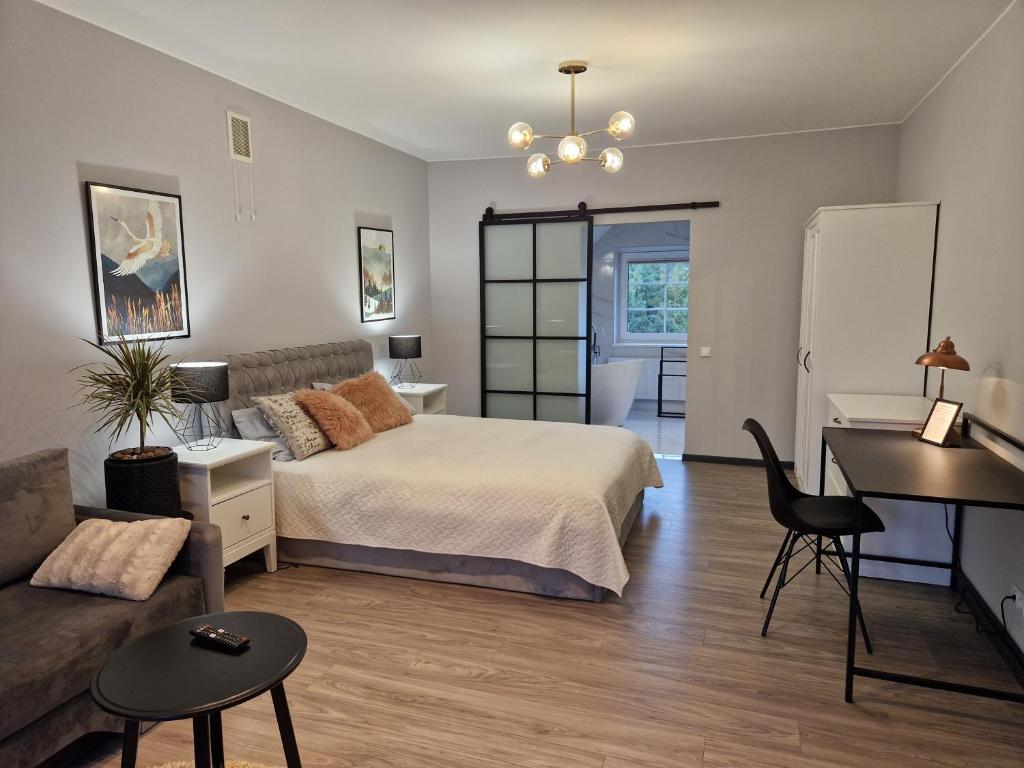 a bedroom with a bed and a desk and a piano at Seliu 25 Homestay Apartment poilsio namai in Šiauliai