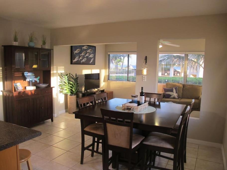 a dining room and living room with a table and chairs at Fabulous one bedroom in West Bay in West Bay