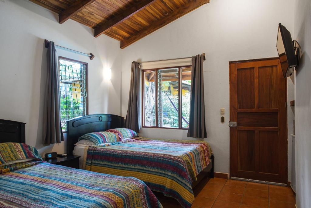 Postel nebo postele na pokoji v ubytování Villas Macondo