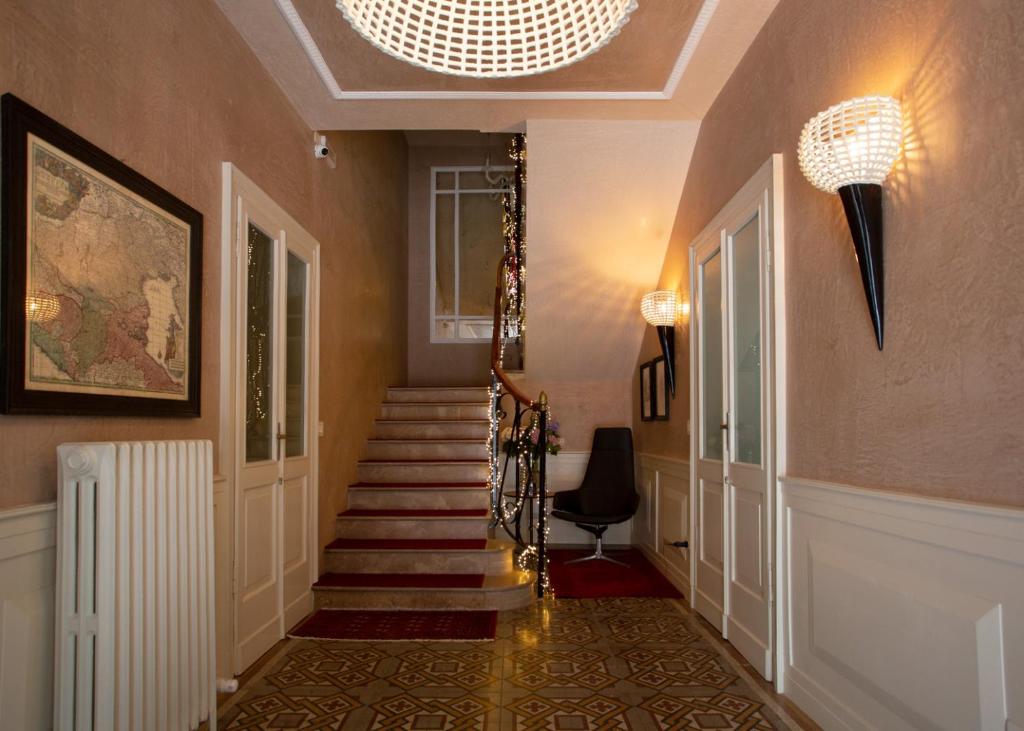 a hallway with stairs and a chandelier at La Casa di Loto Suite in Cittadella
