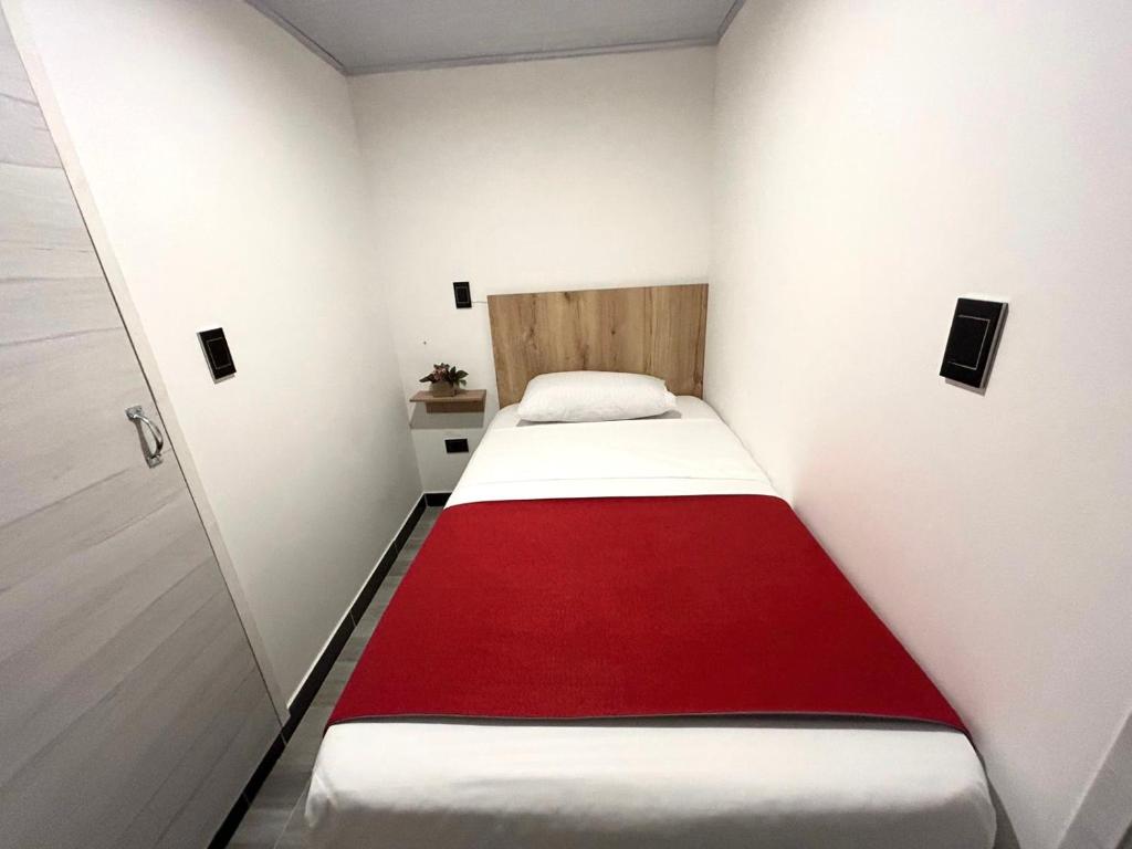 Postel nebo postele na pokoji v ubytování Hotel Urban Center Bogota