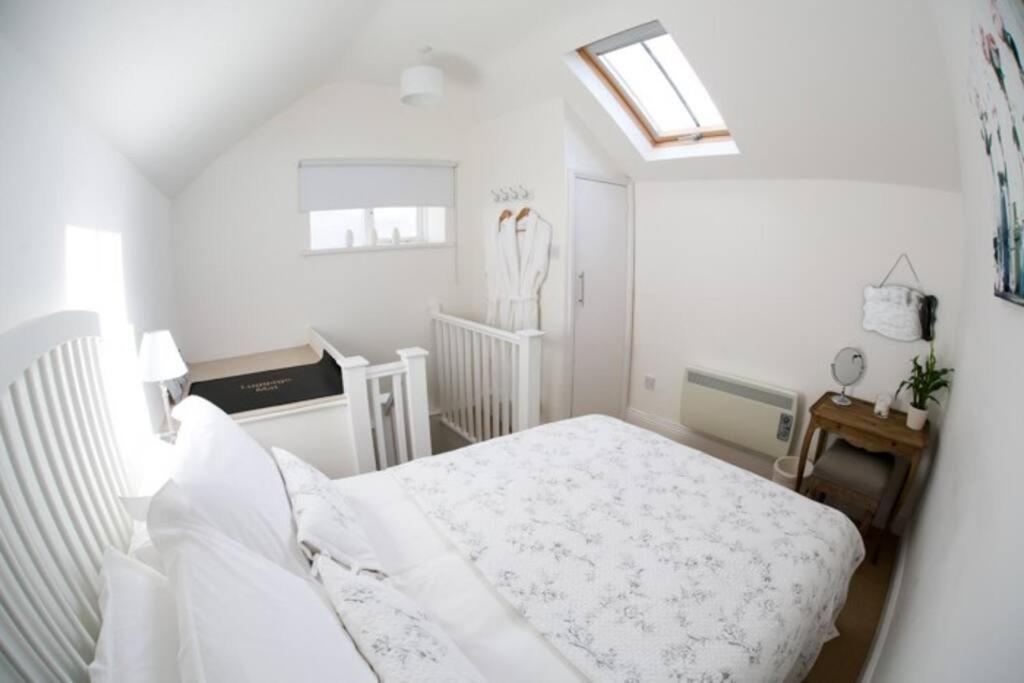 מיטה או מיטות בחדר ב-Detached Cotswold Stone Coach House