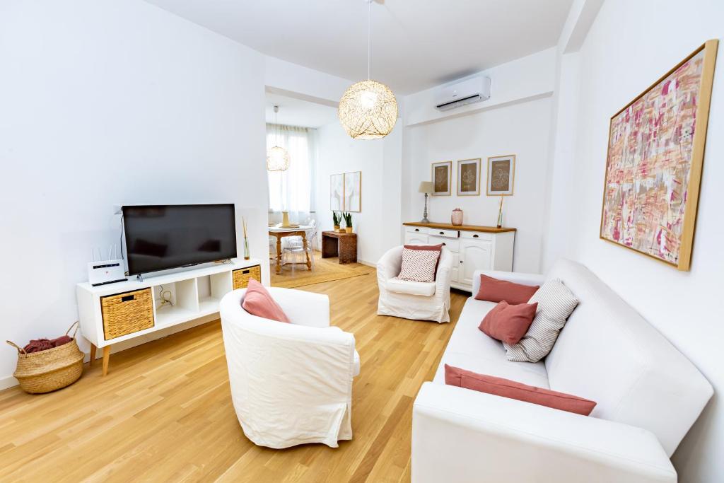 un salon avec des meubles blancs et une télévision à écran plat dans l'établissement Noh collection 3BDR apartment- Trastevere Area, à Rome