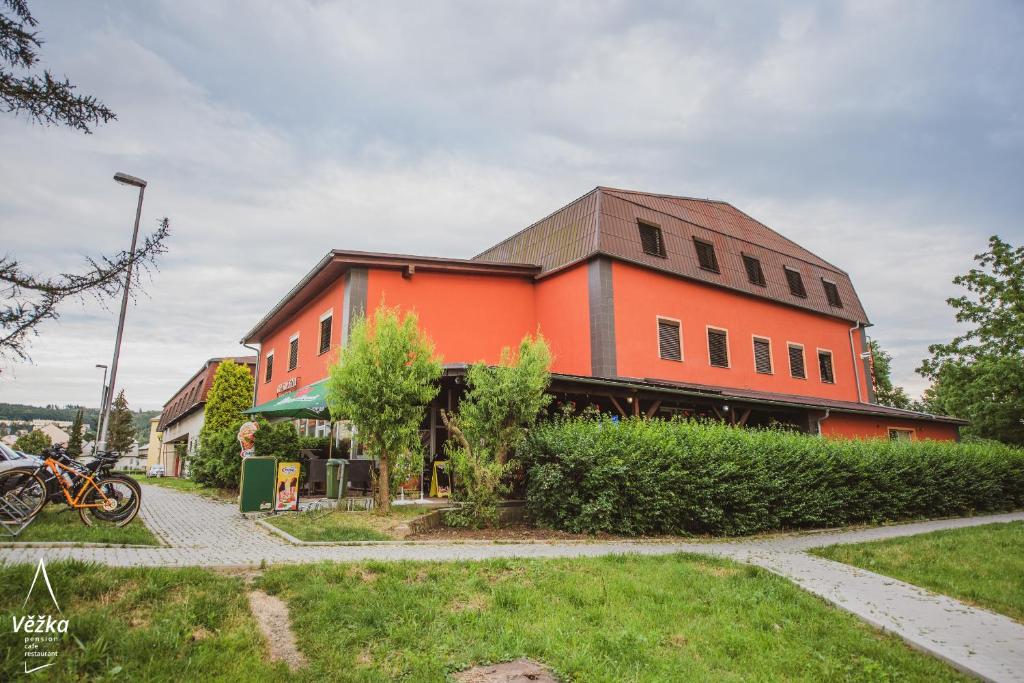 a large orange building with at Pension Věžka in Šternberk