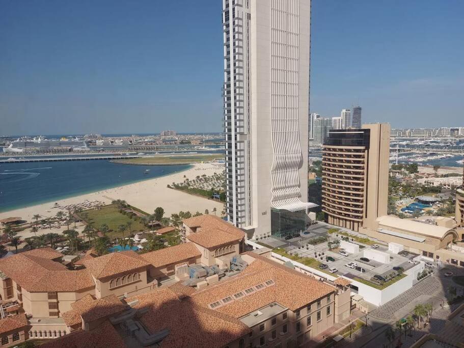 an aerial view of a city with buildings and the ocean at Sunset Oasis: Beachfront Studio in Dubai