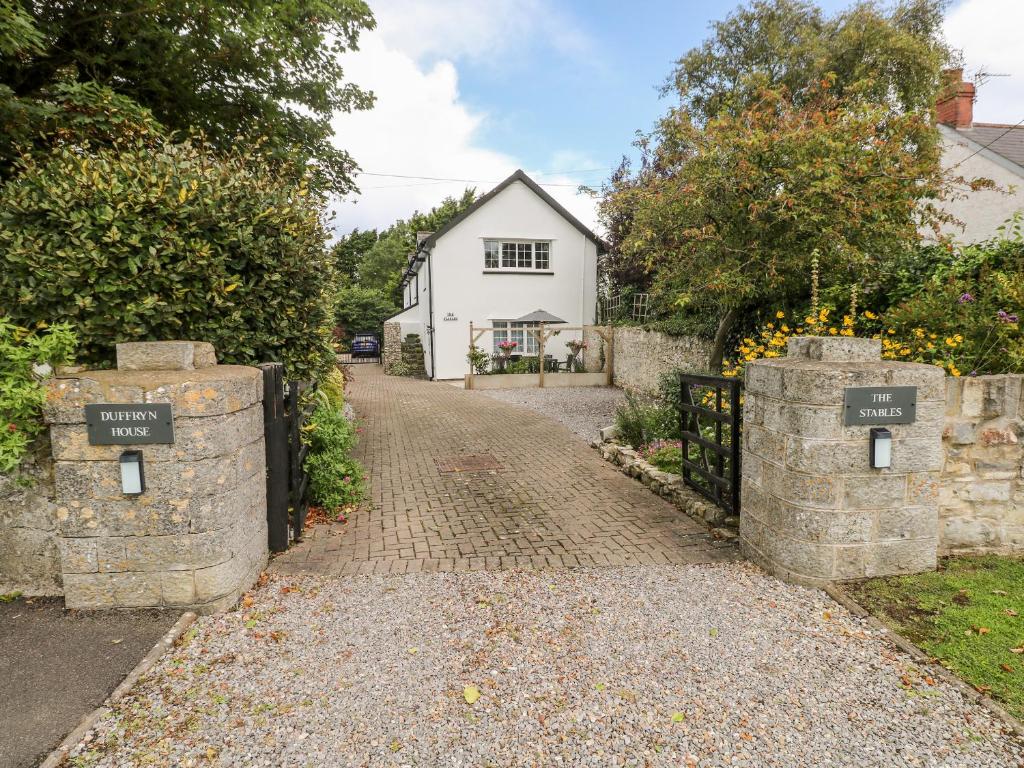 a driveway leading to a house with signs on it at The Stables in Flemingston